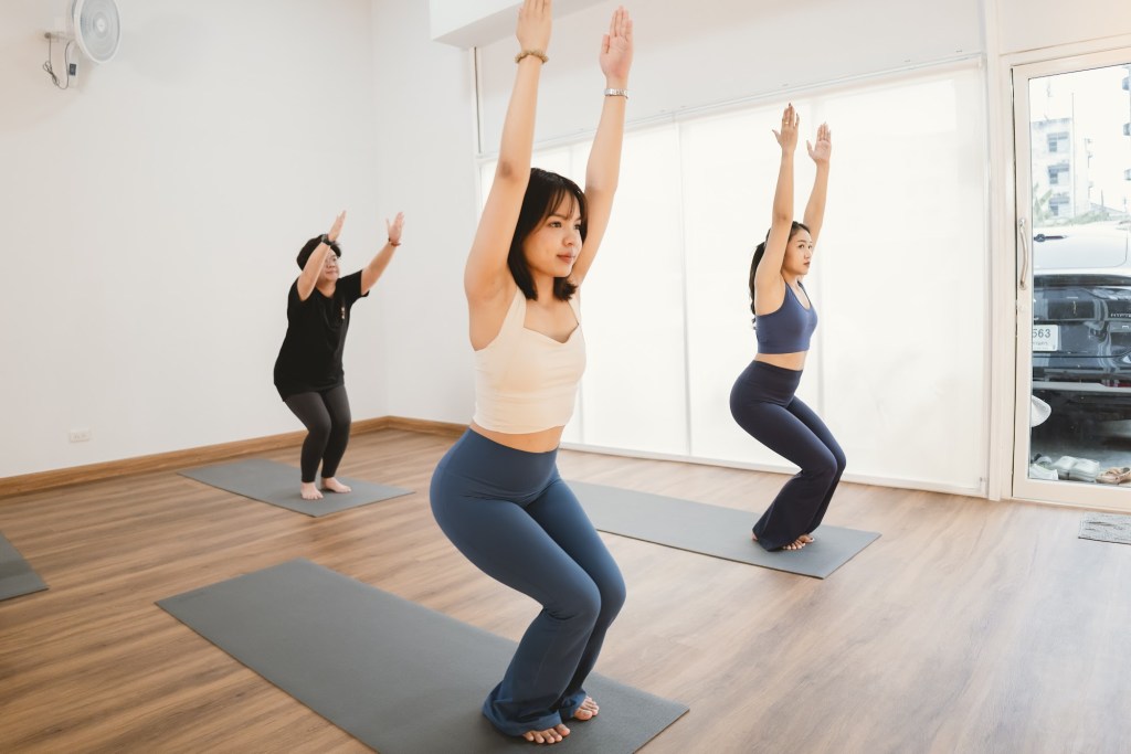 Yoga class in chair pose