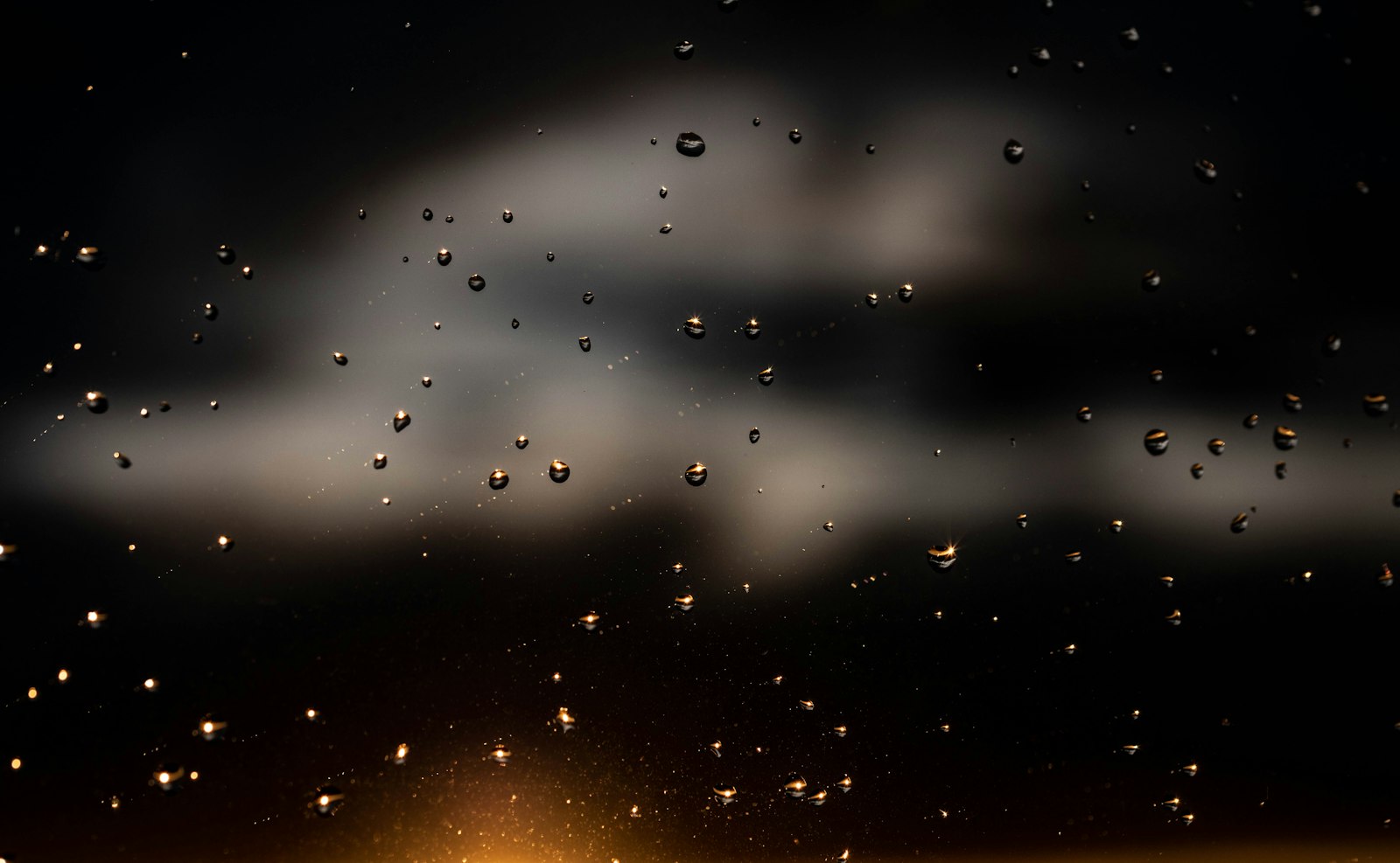 Raindrops on a window glass at the end of the rainy season